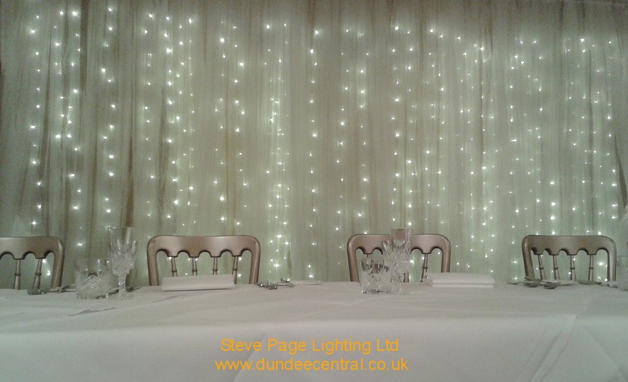 white backdrop with fairylights hire